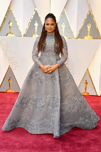 red carpet grey dresses Halle Berry lit up the 2025 Oscars red carpet in a dazzling metallic silver gown by Christian Siriano. The strapless design featured a structured bodice with stained glass-style silver pieces, intricate embroidery,